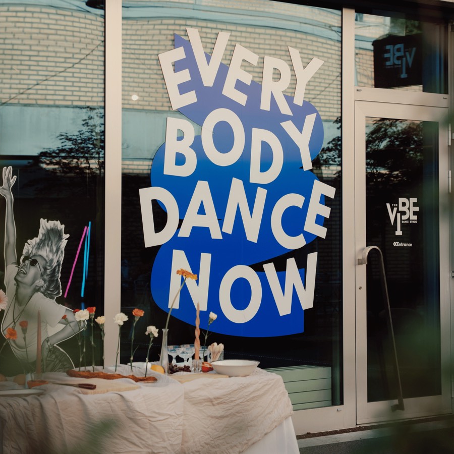 The Vibe Dance Studio storefront in Zurich with a hand-painted 'Everybody Dance Now' window mural, decorated for the studio's 2nd anniversary celebration.